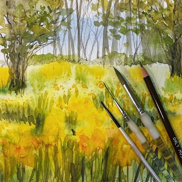 Watercolor painting of a sunny field with yellow flowers, trees, and four paintbrushes.
