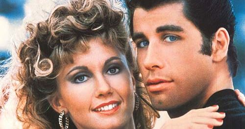 Grease film poster showing a smiling couple embracing, with the title 