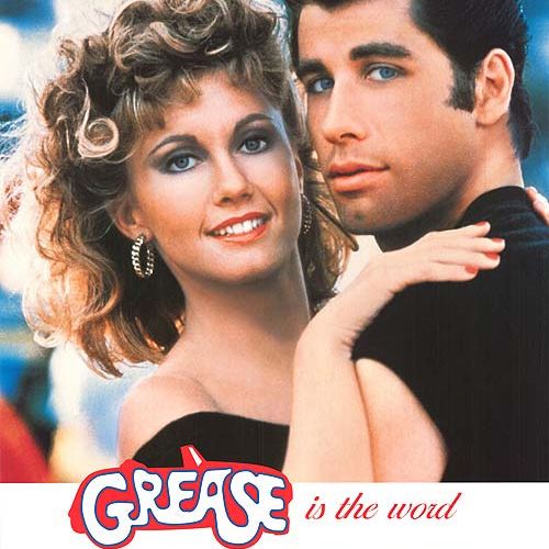 Grease film poster showing a smiling couple embracing, with the title 