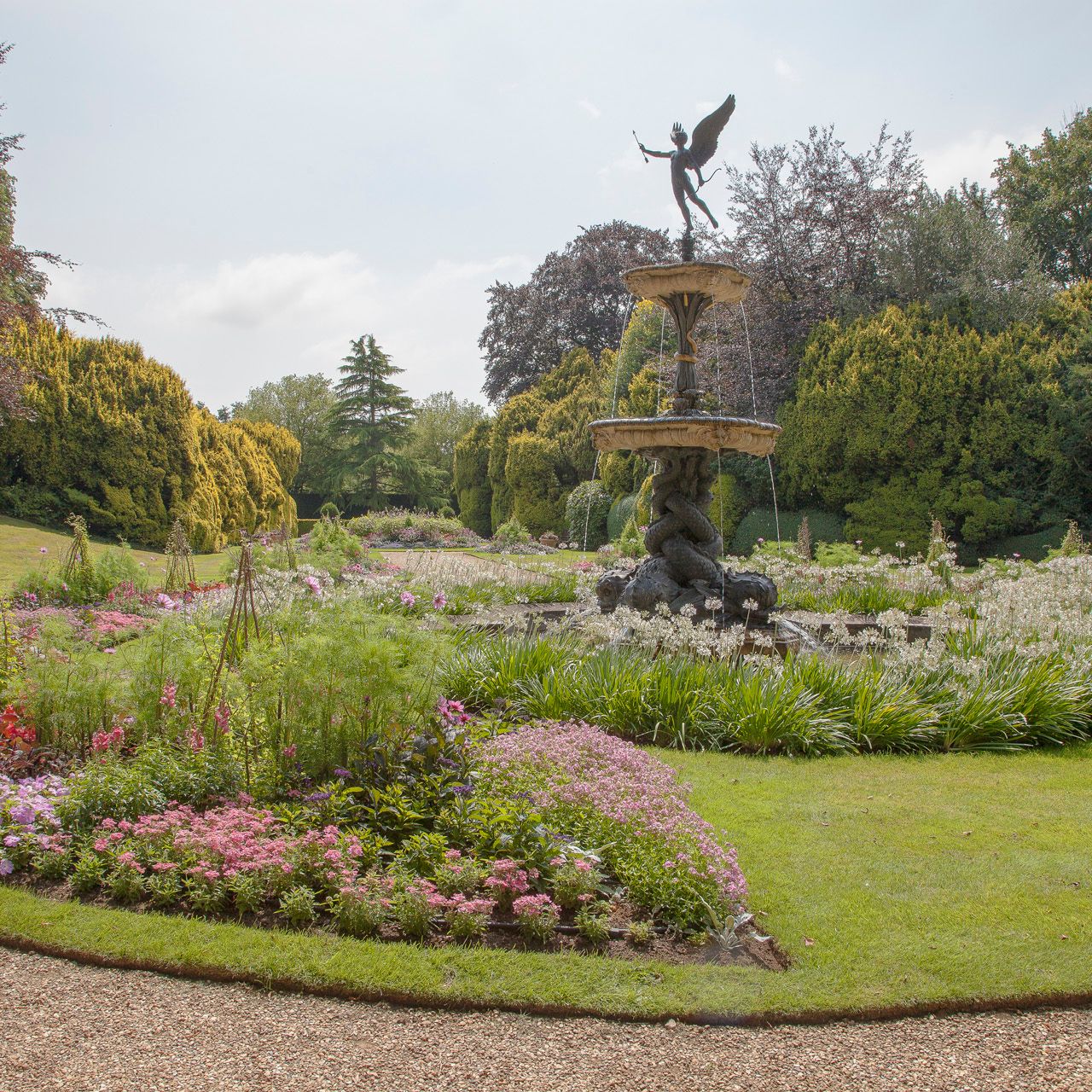 Garden with a large decorative fountain and colorful flower beds