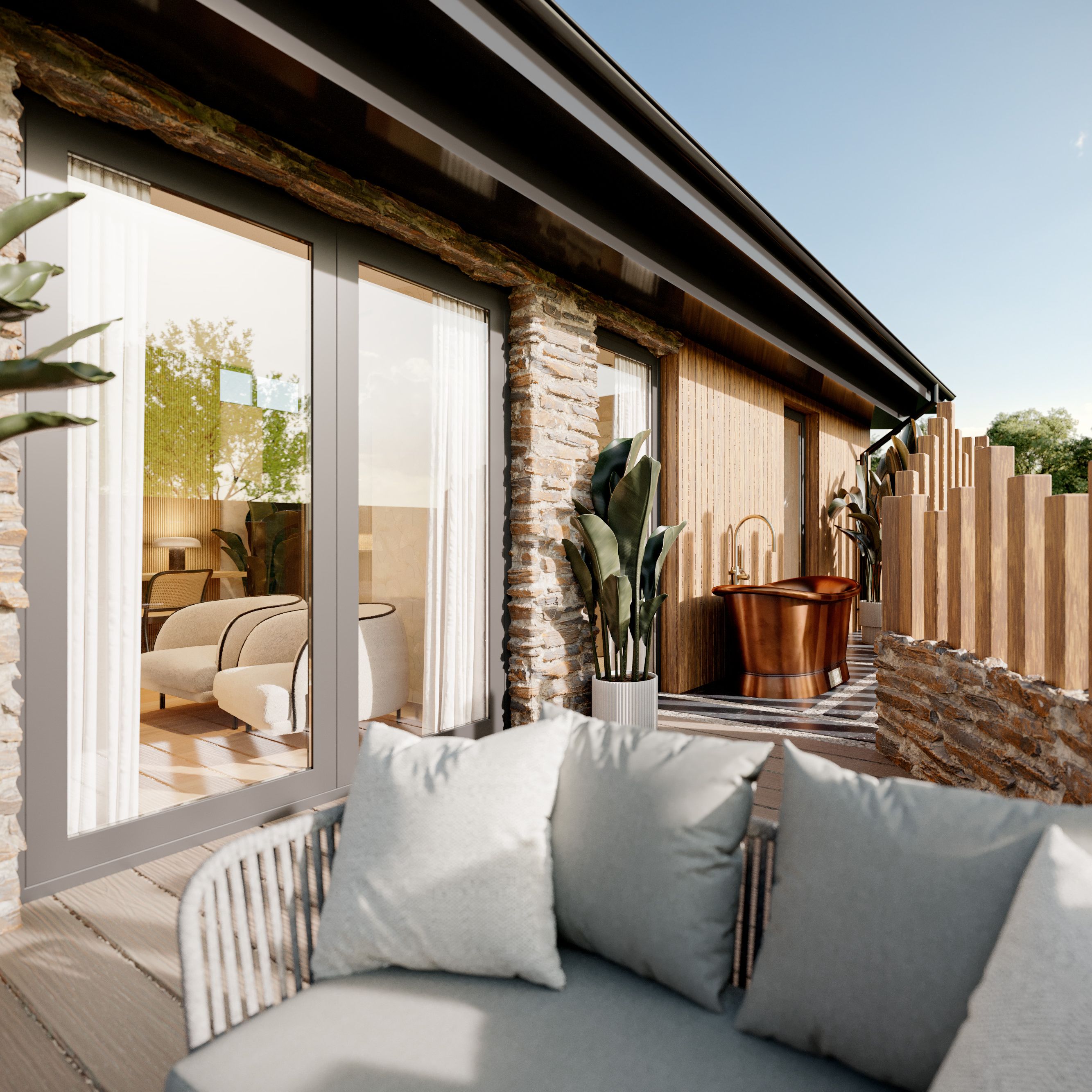 Luxury suite with stone walls, outdoor seating area, potted plants, and a copper bathtub on a private terrace