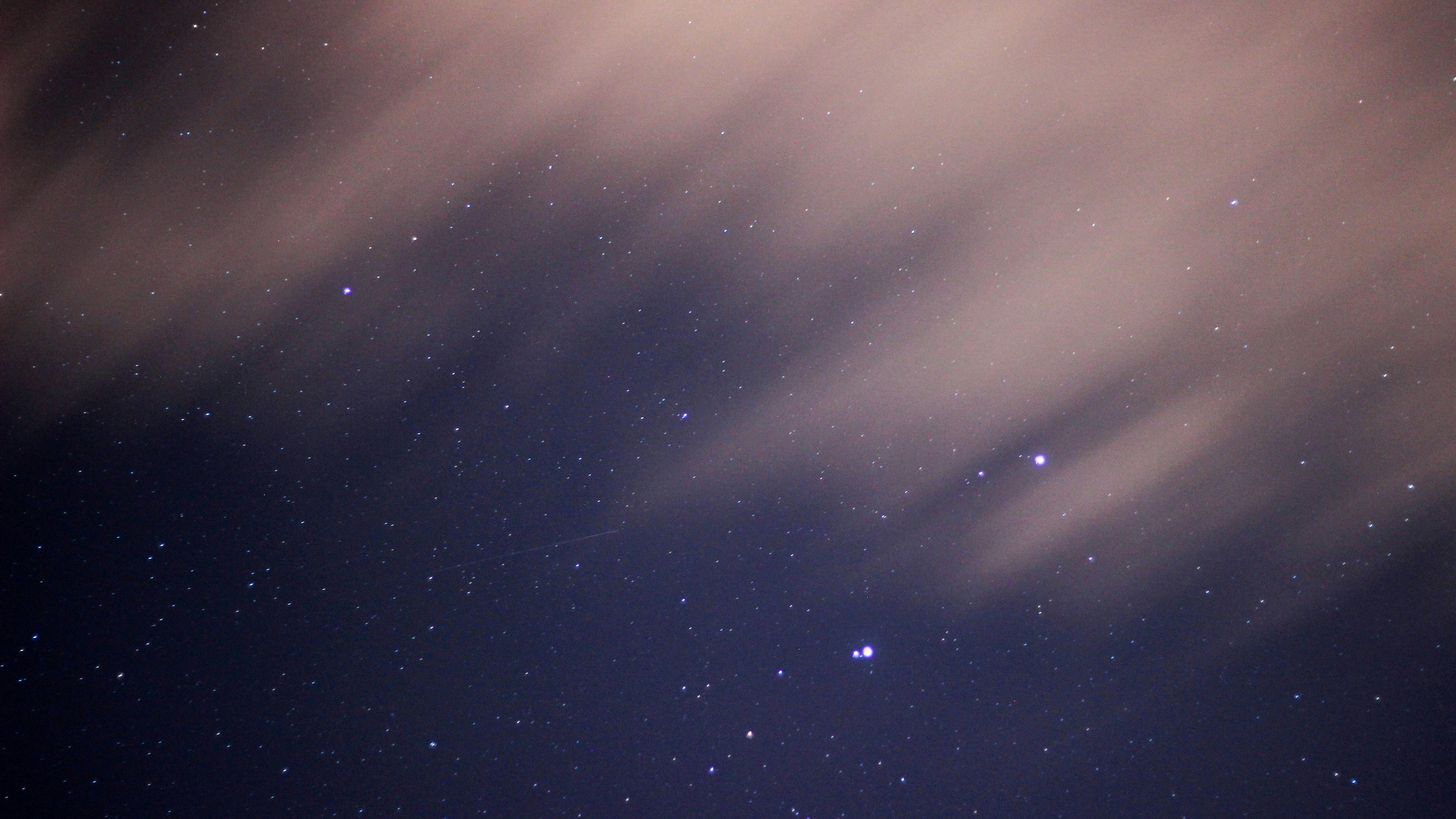 Night sky with stars and streaks of clouds