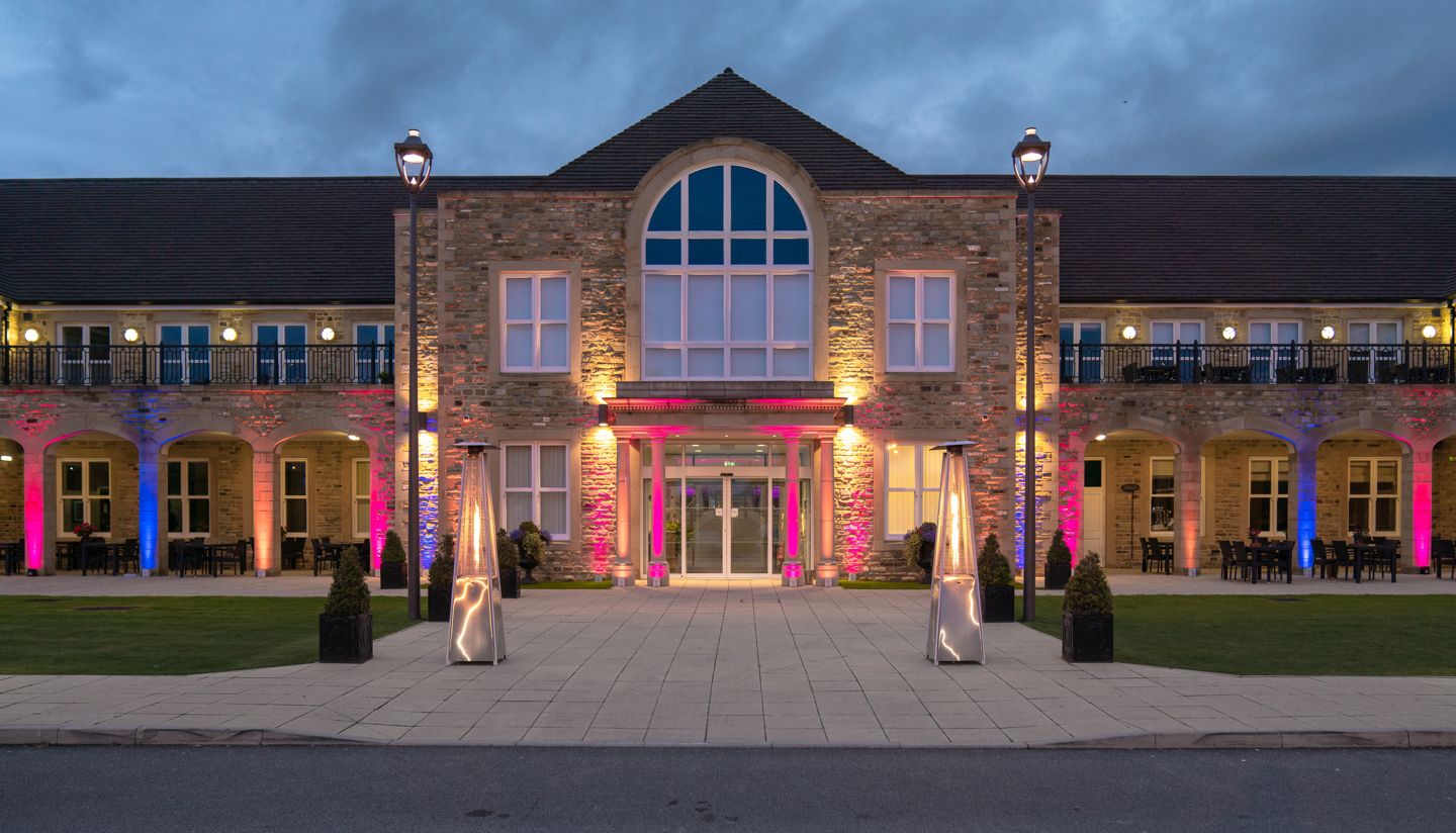 Tennants garden rooms from the outside showing a large stone brick building with lights