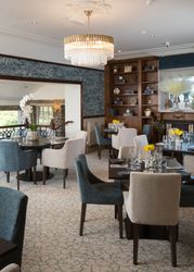 Elegant restaurant dining area with modern decor and chandelier