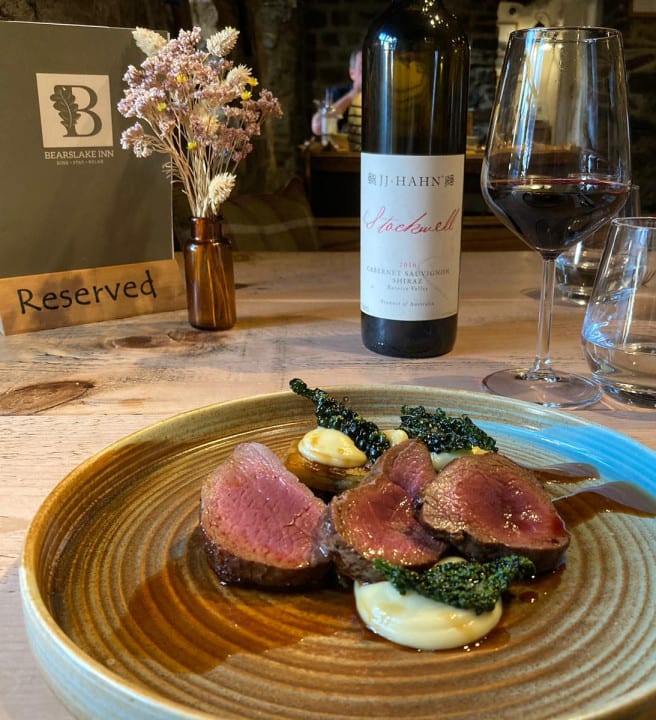 venison dinner with bottle of wine