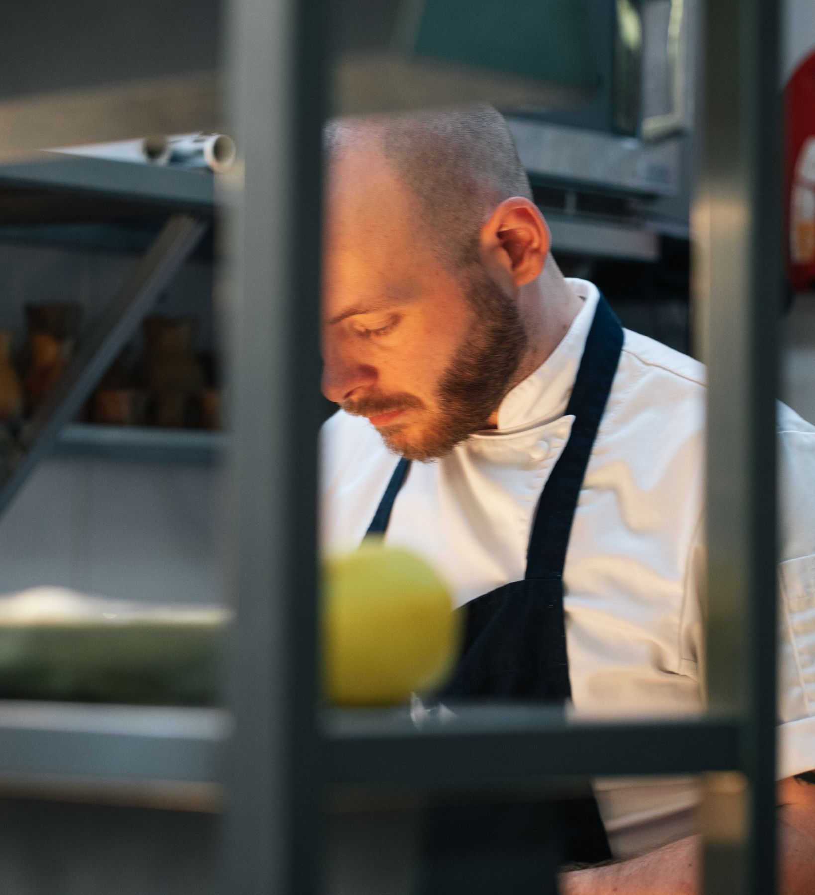 Chef working in a kitchen, focused on food preparation