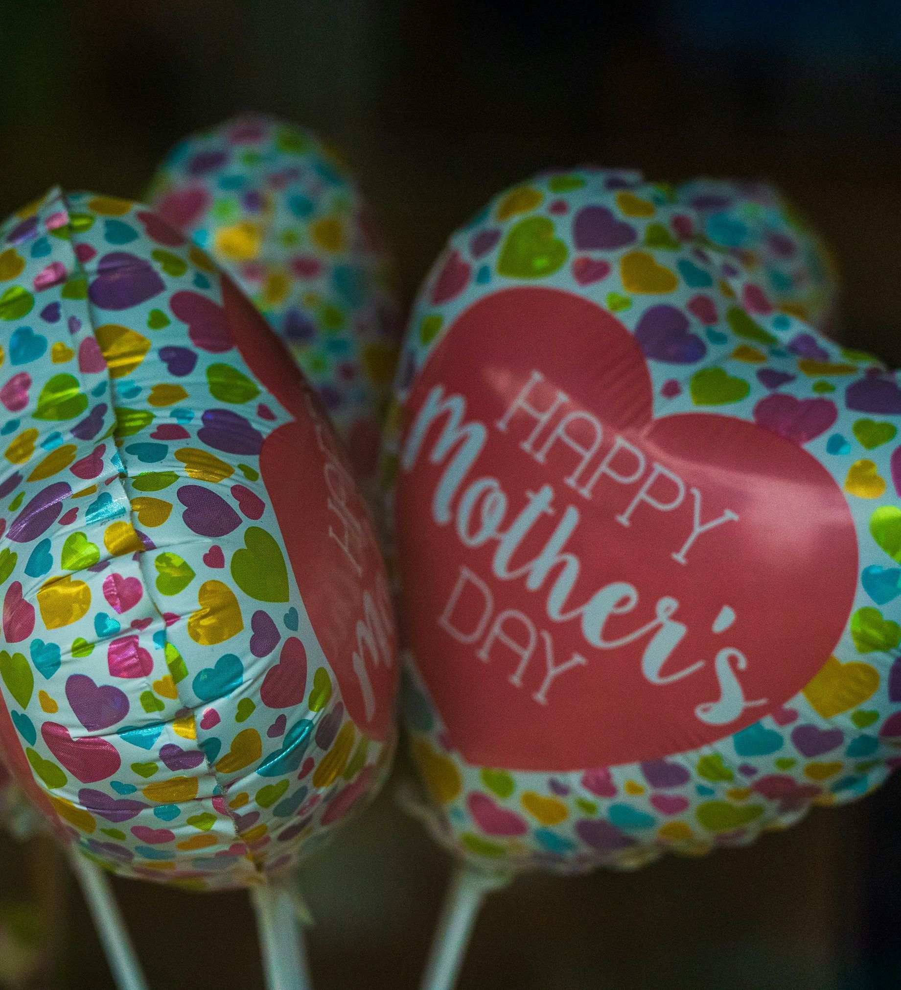 Heart-shaped balloons with colorful hearts and 'Happy Mother's Day' printed on them