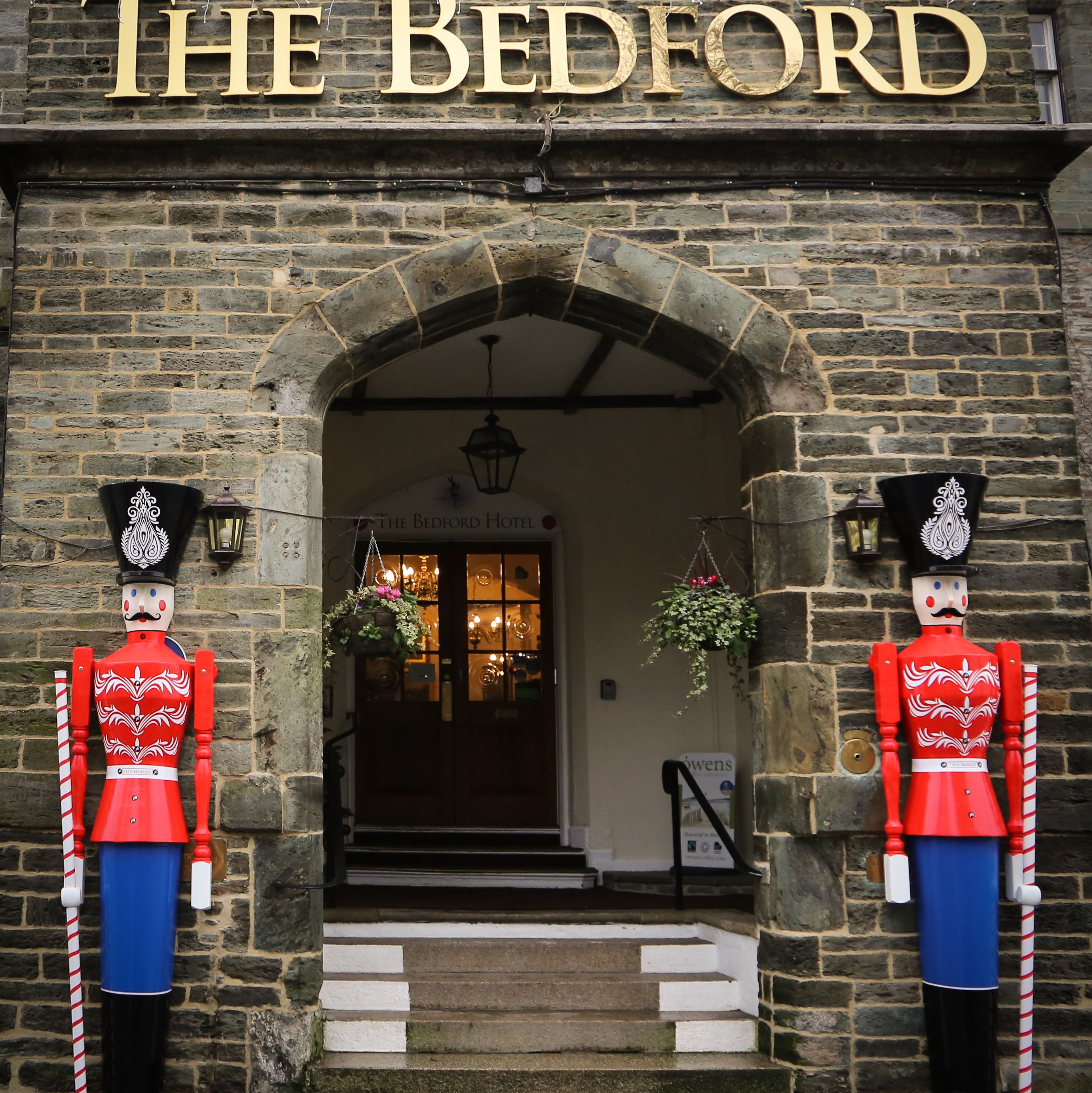 Entrance of The Bedford Hotel decorated with two large toy soldier figures for Christmas