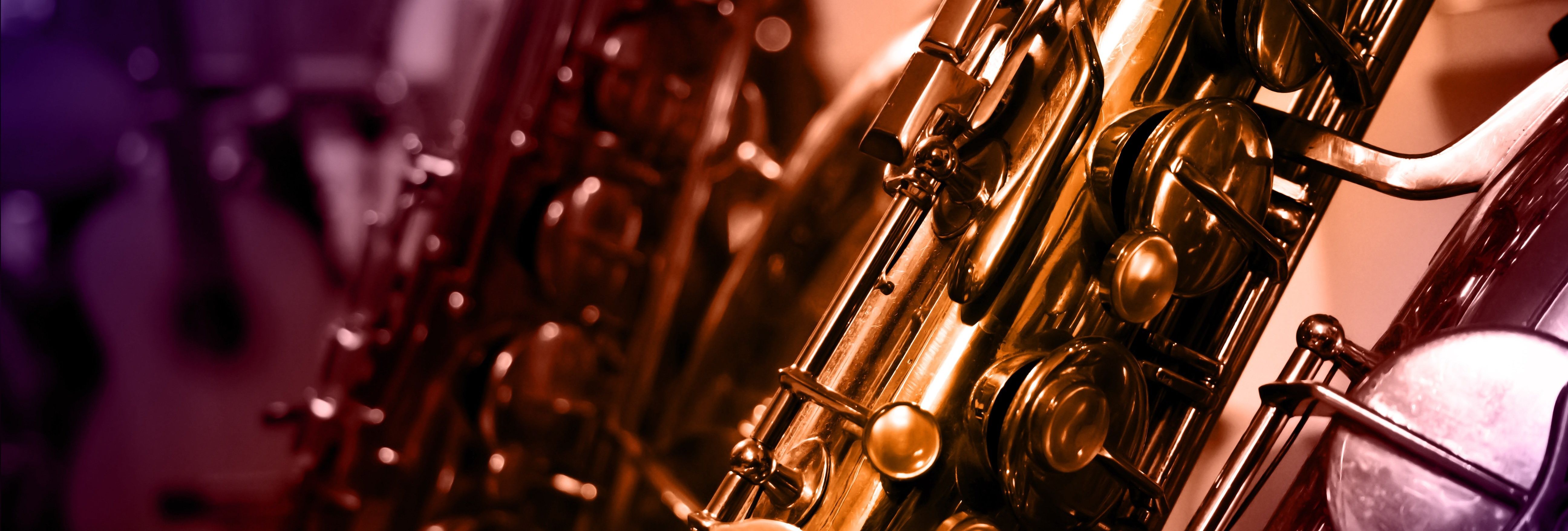 Close-up view of a saxophone with colorful lighting