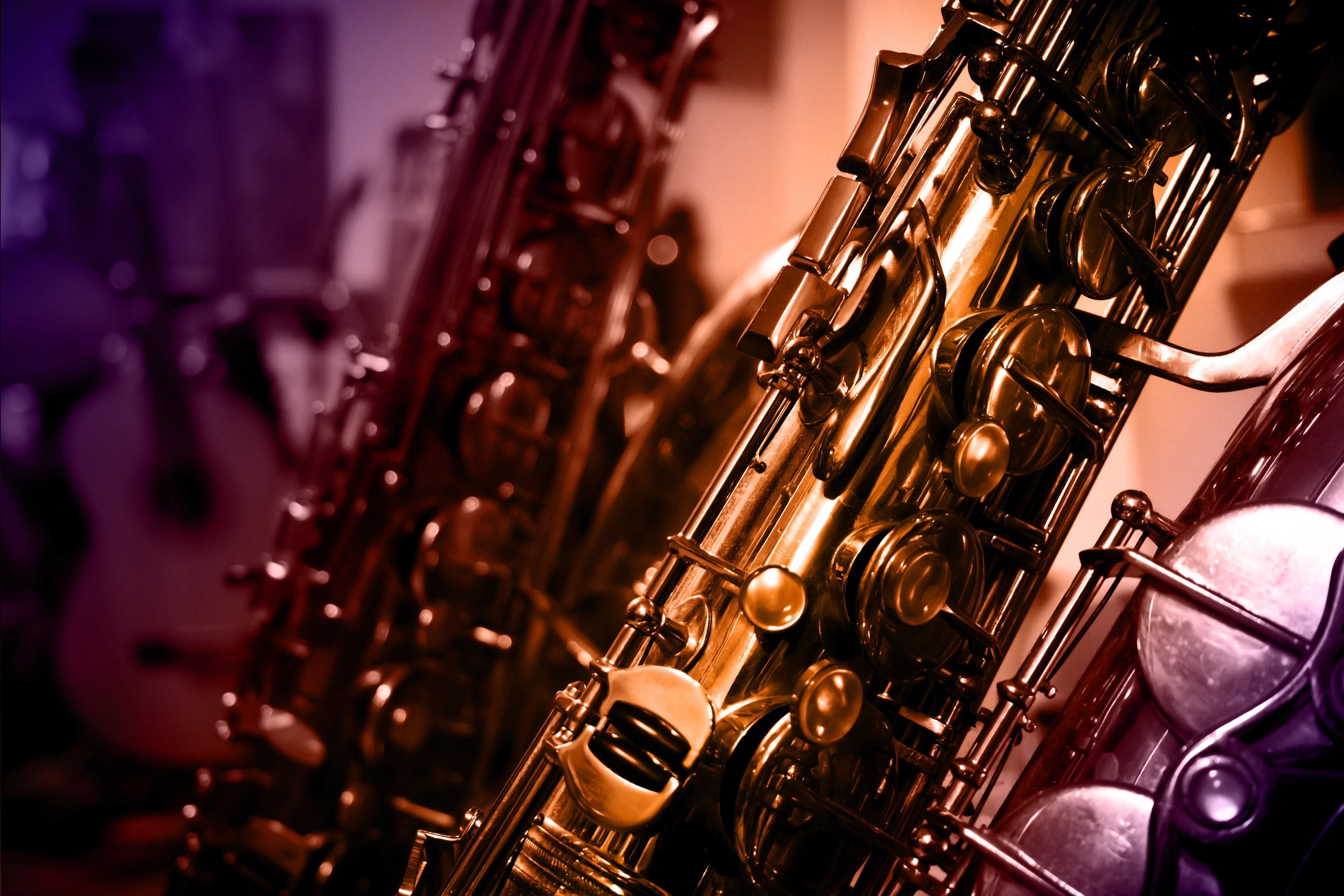 Close-up of a saxophone with warm lighting and blurred background
