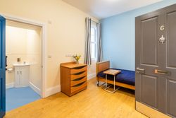 Bedroom with blue bedding and wet room