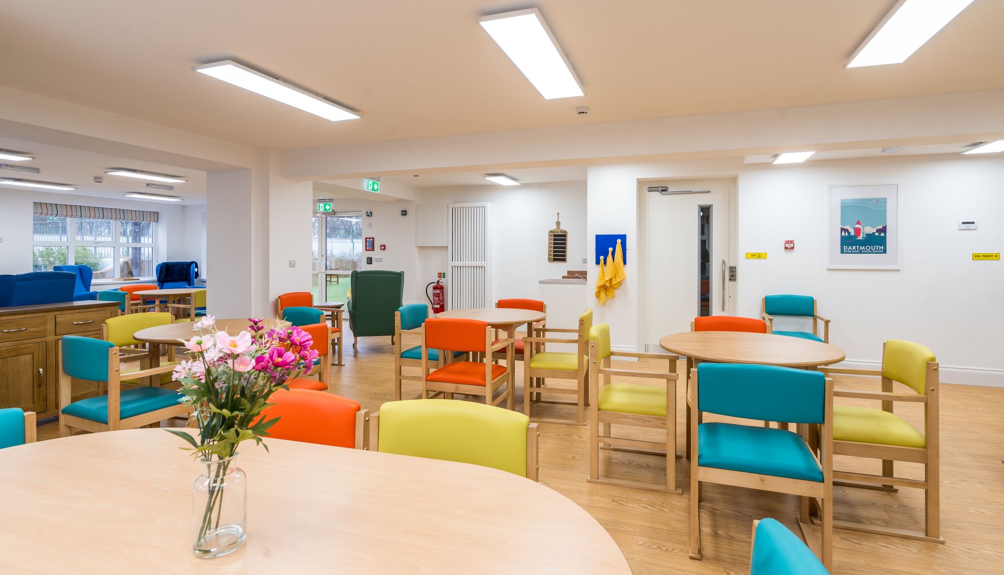 Room with colourful chairs around tables