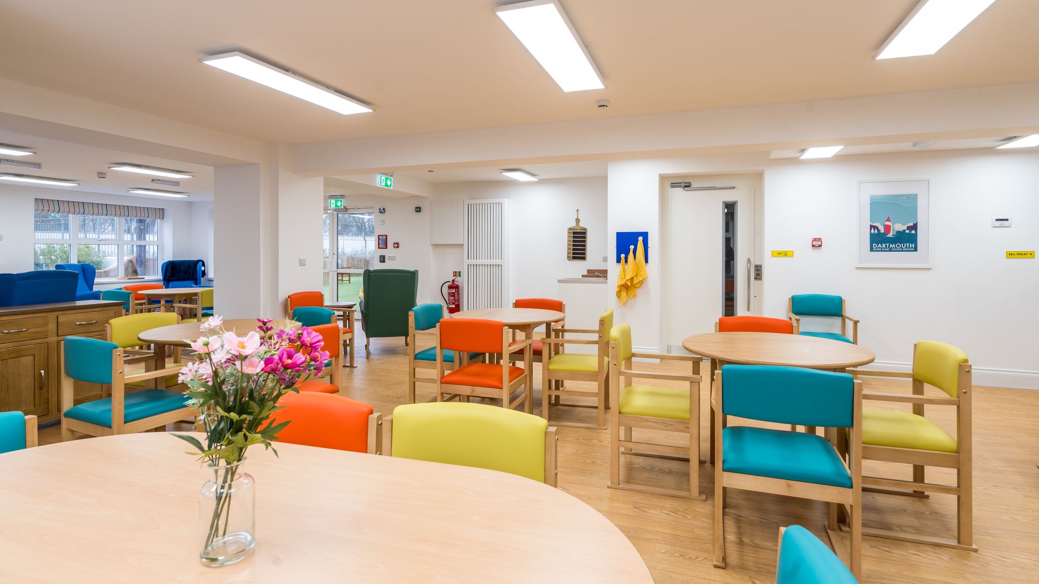 Room with colourful chairs around tables