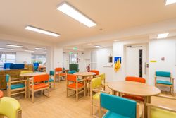 Room with colourful chairs around tables