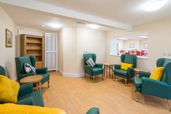 Green armchairs with yellow cushions in living area