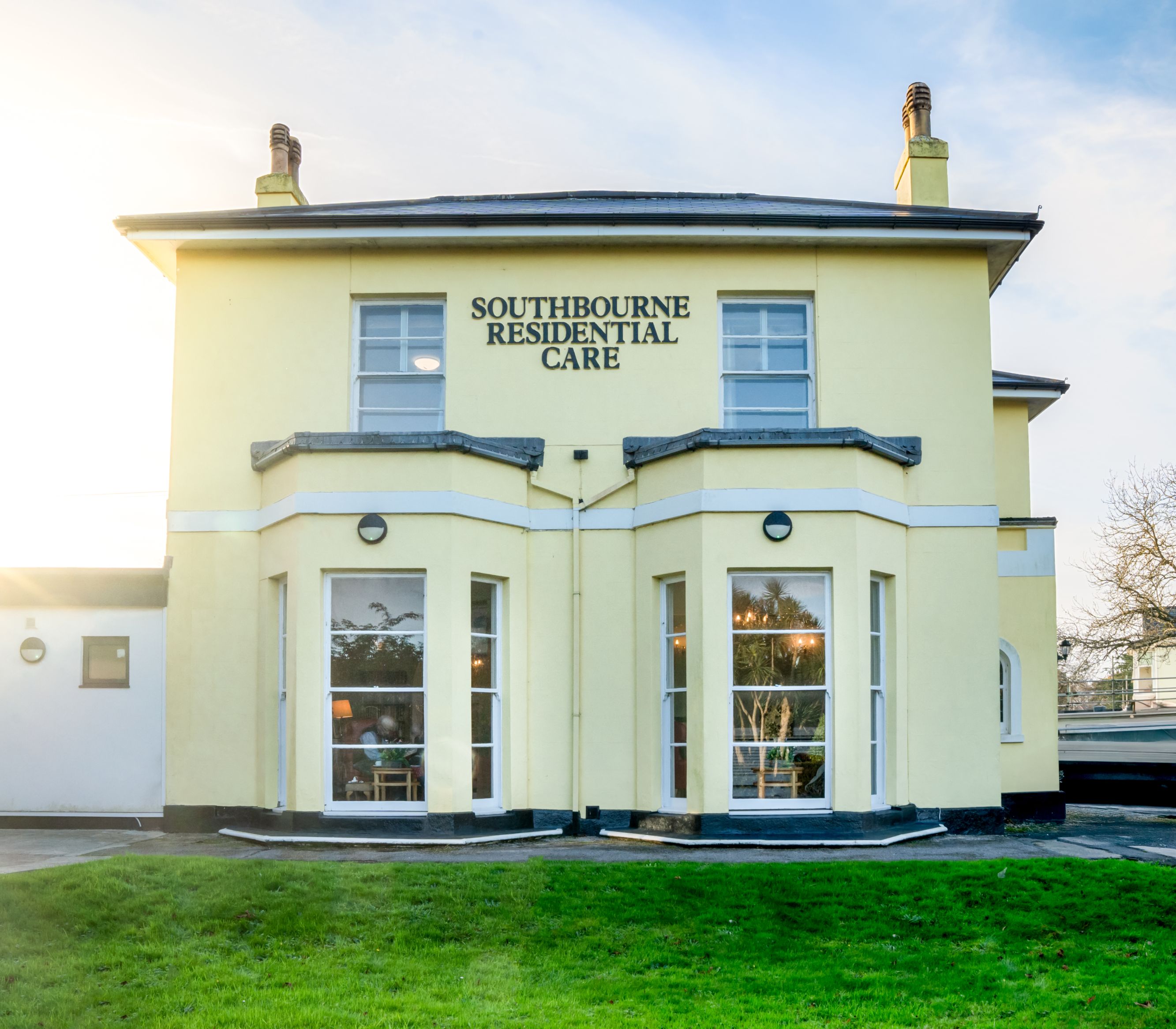 A yellow two-story building labeled 