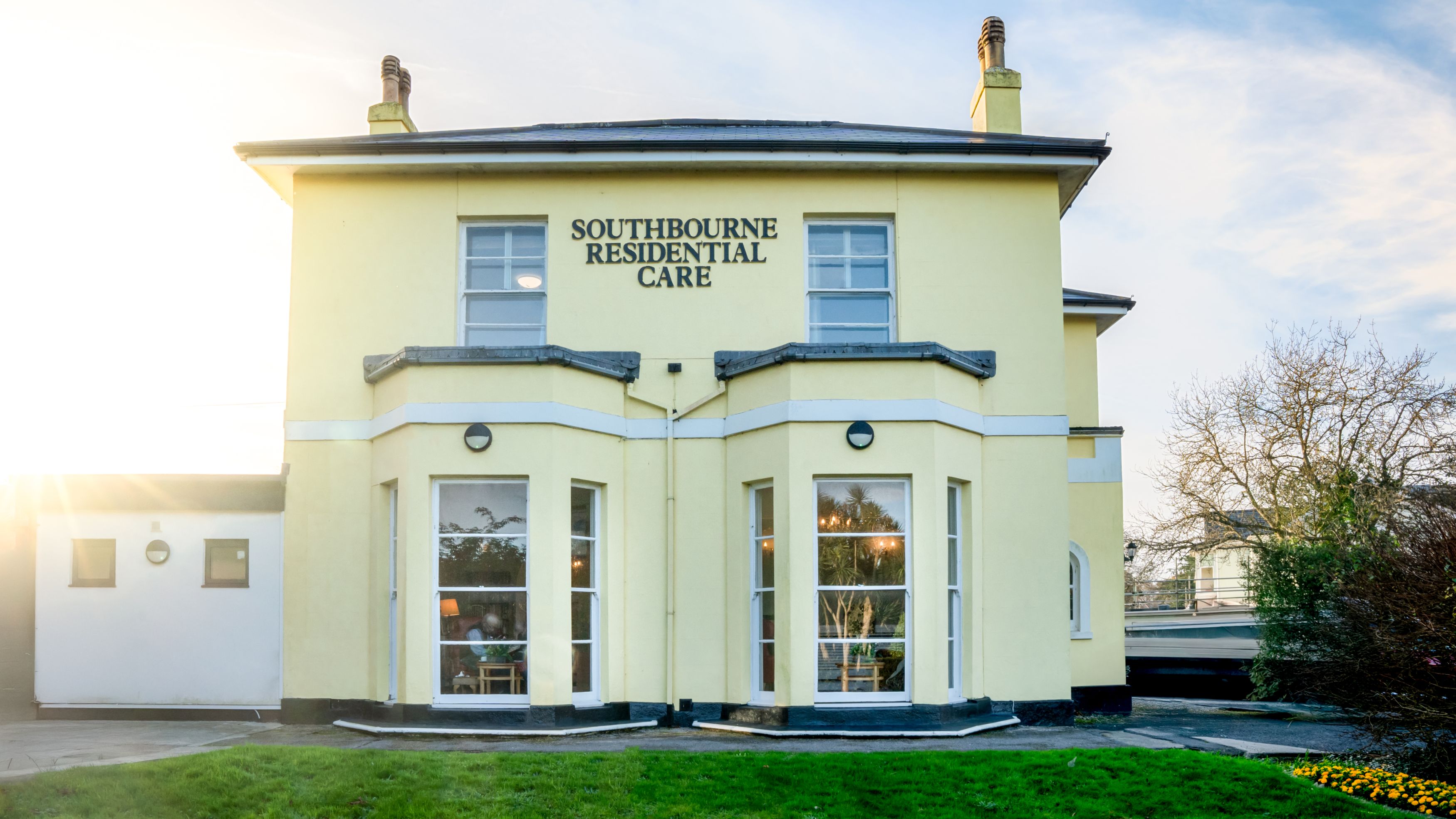 A yellow two-story building labeled 