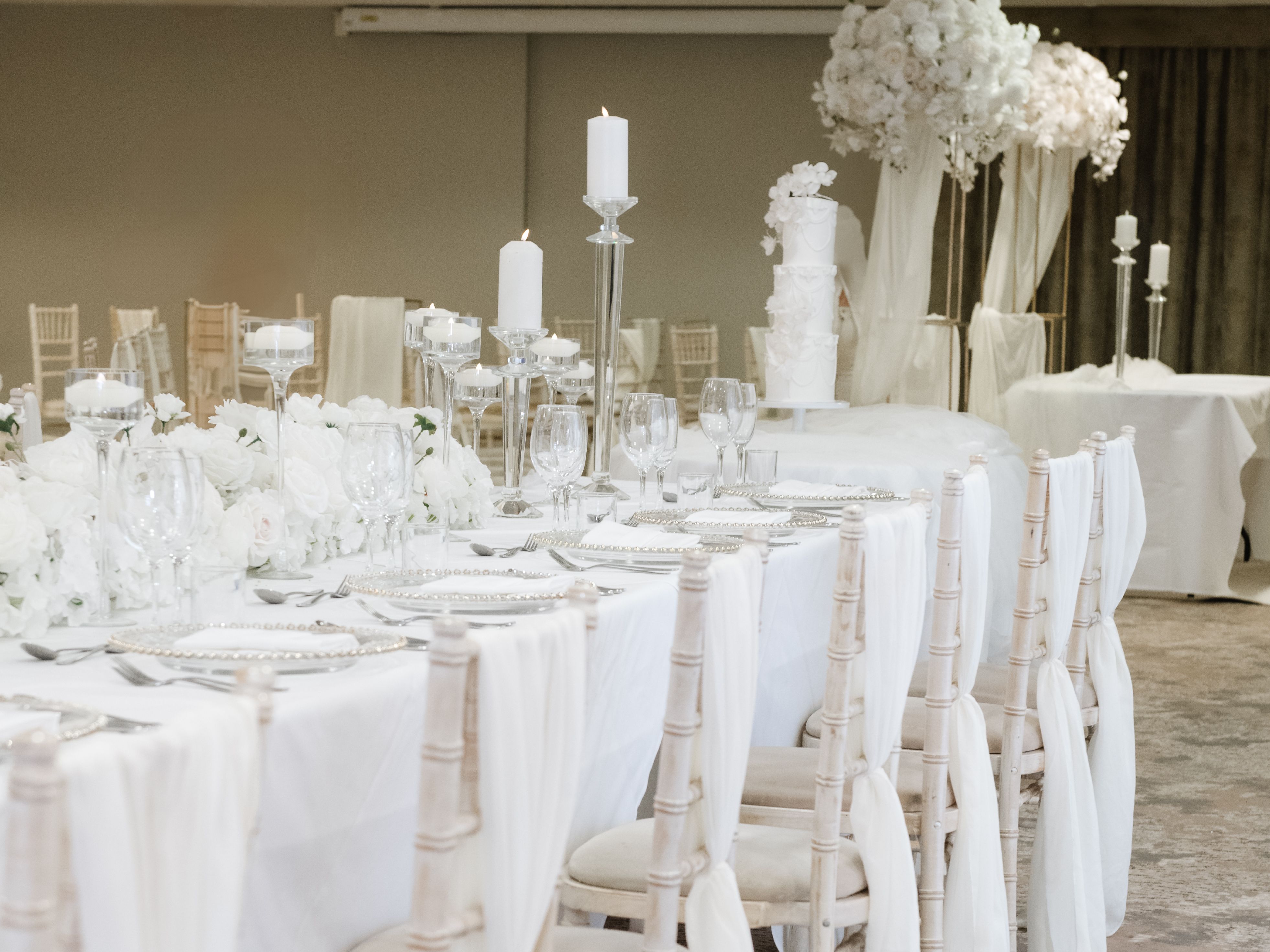Elegant wedding reception table with white decorations and candles