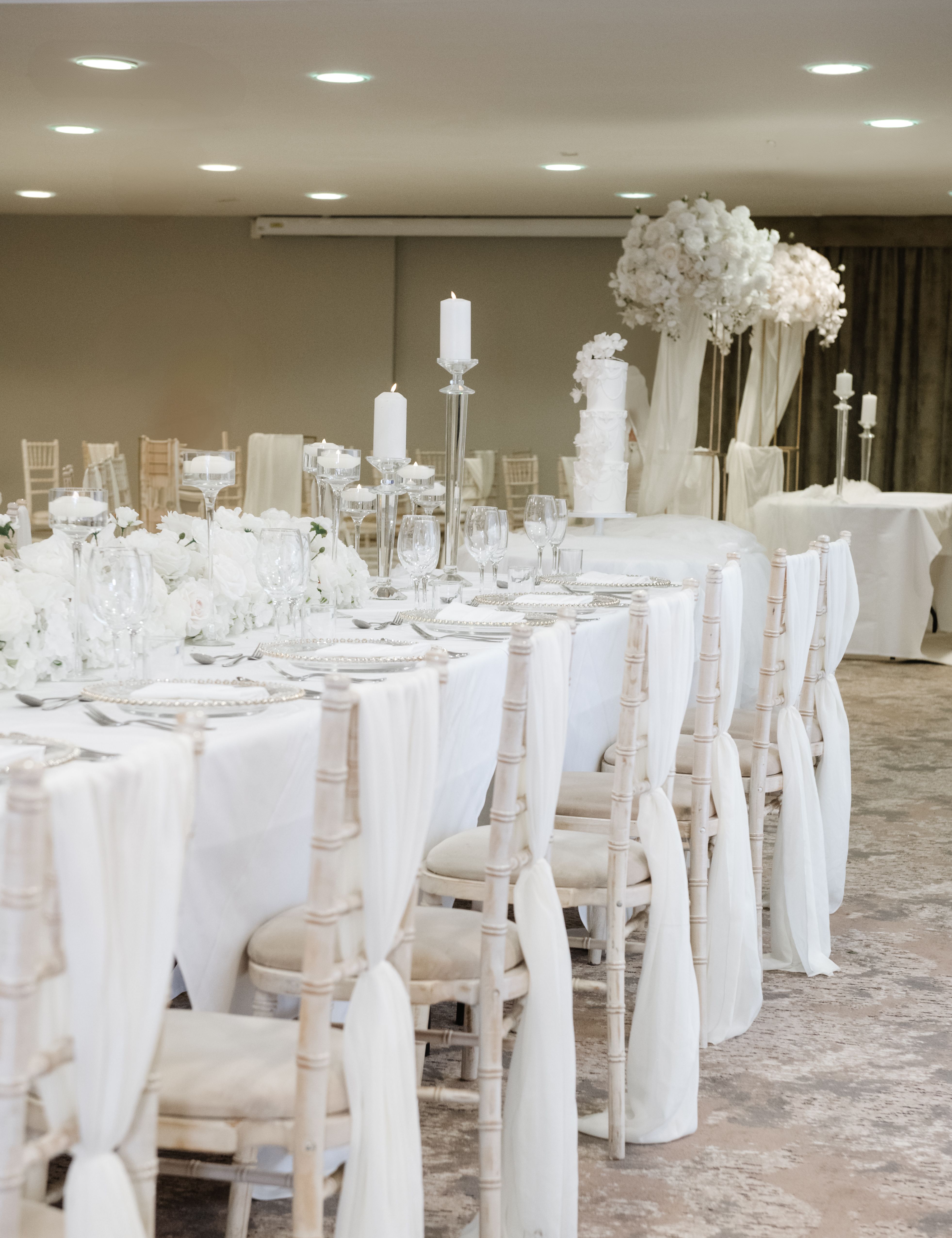 Elegant wedding reception table with white decorations and candles