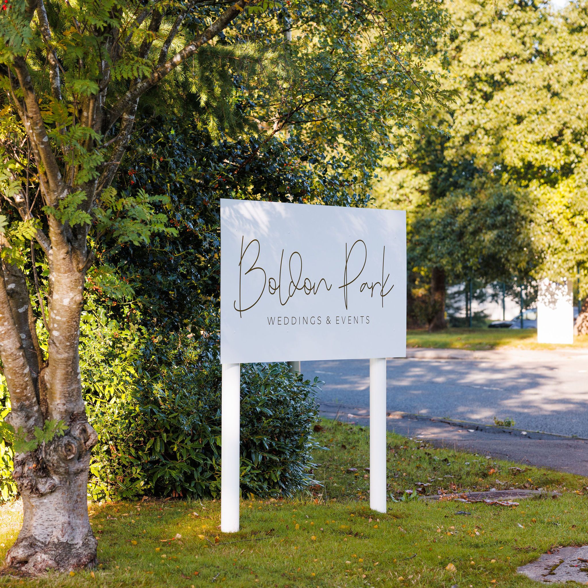 Sign for Boldon Park Weddings & Events beside a tree and green foliage