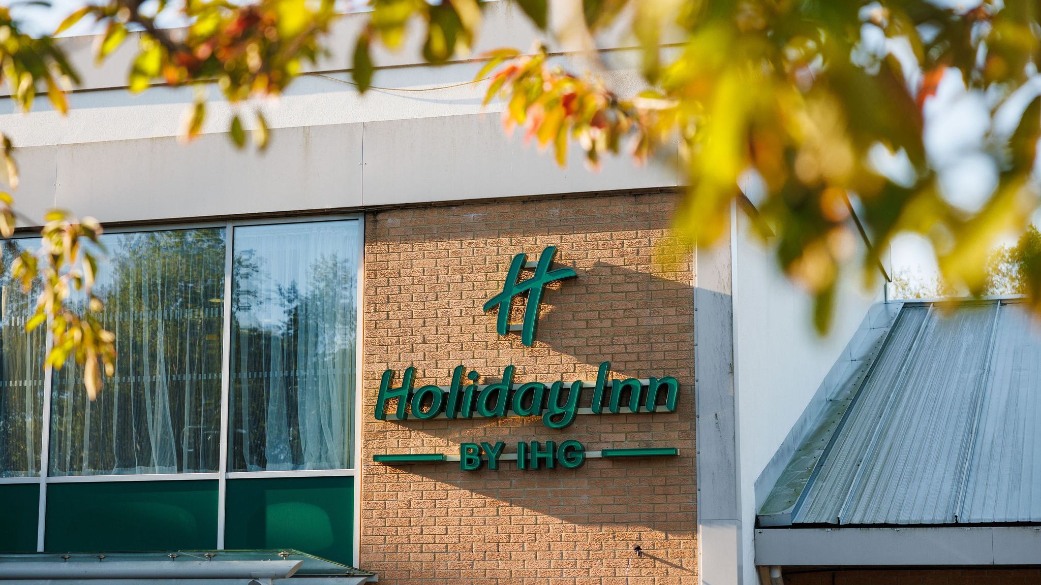 Holiday Inn hotel building exterior with Holiday Inn by IHG sign