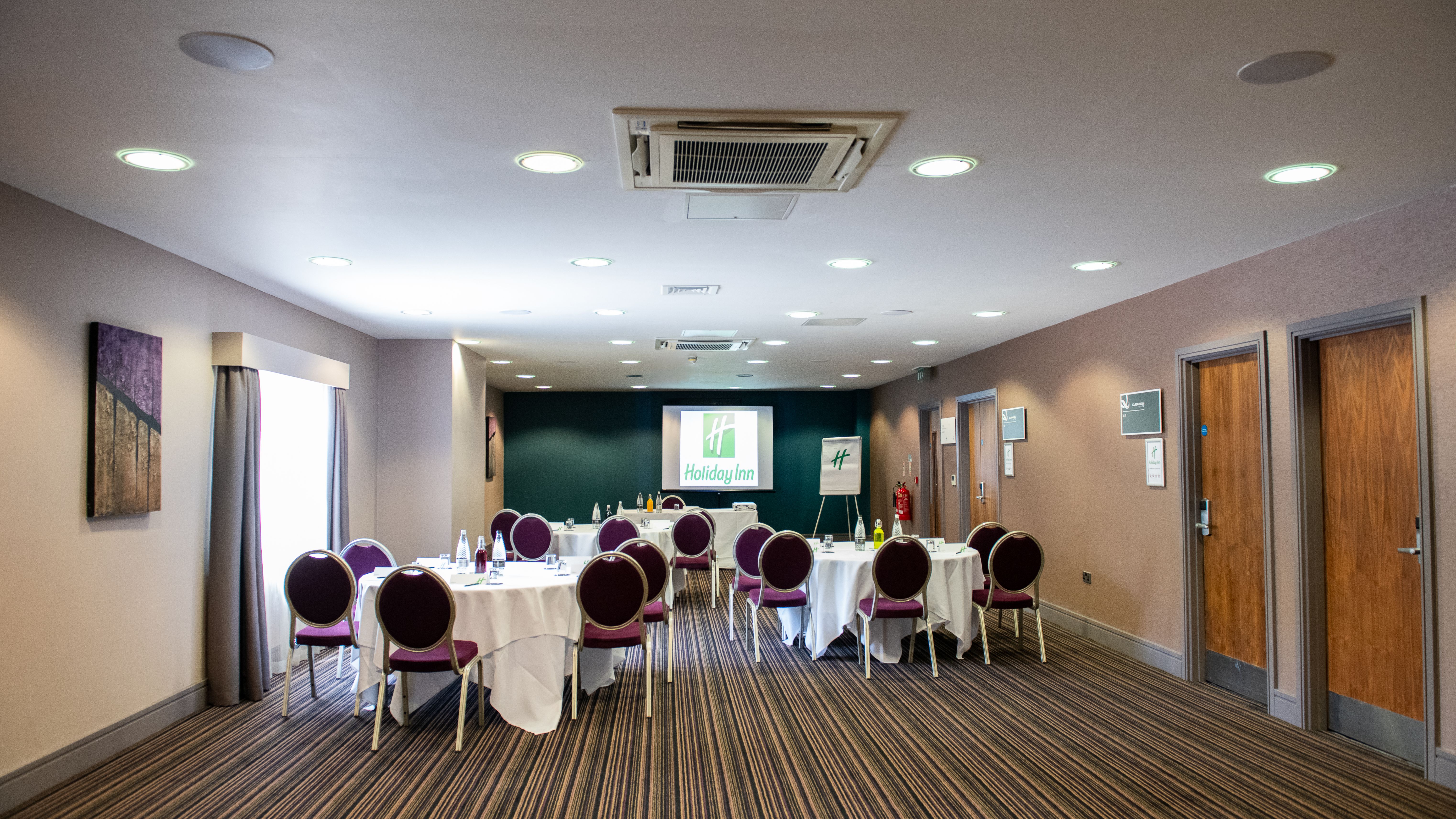 Holiday Inn conference room set up with round tables and chairs