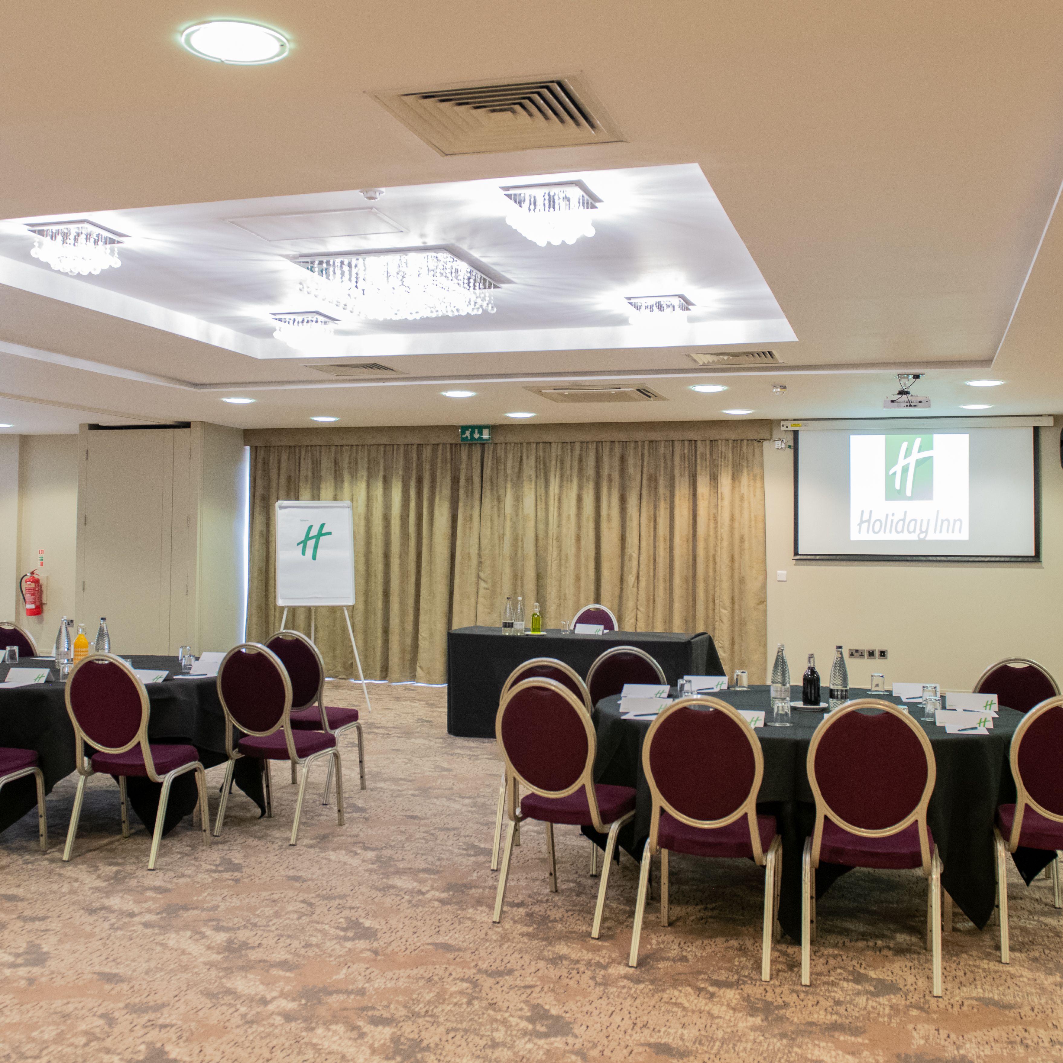 Holiday Inn conference room setup with round tables and chairs