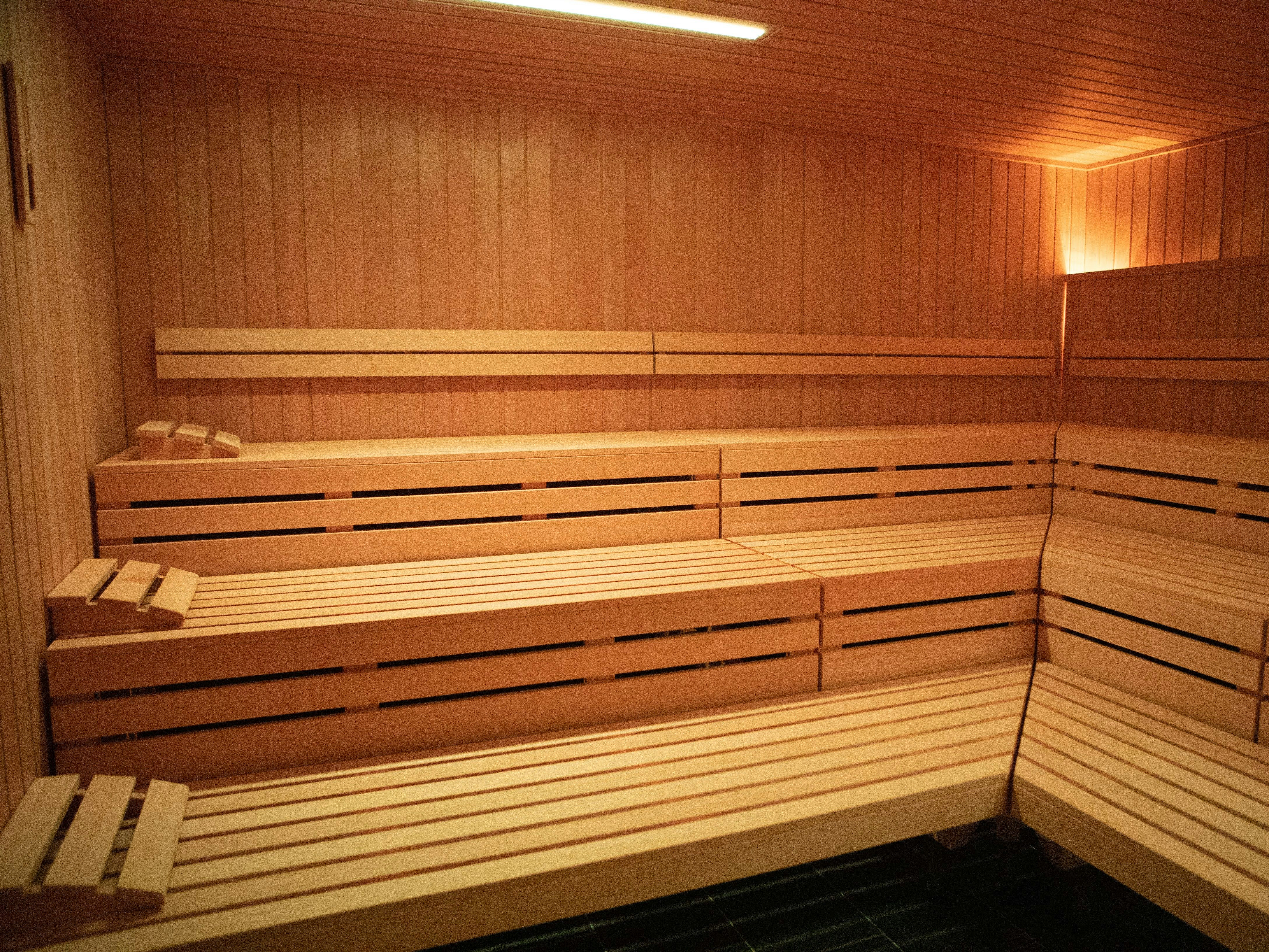 Interior of an empty wooden sauna with tiered bench seating