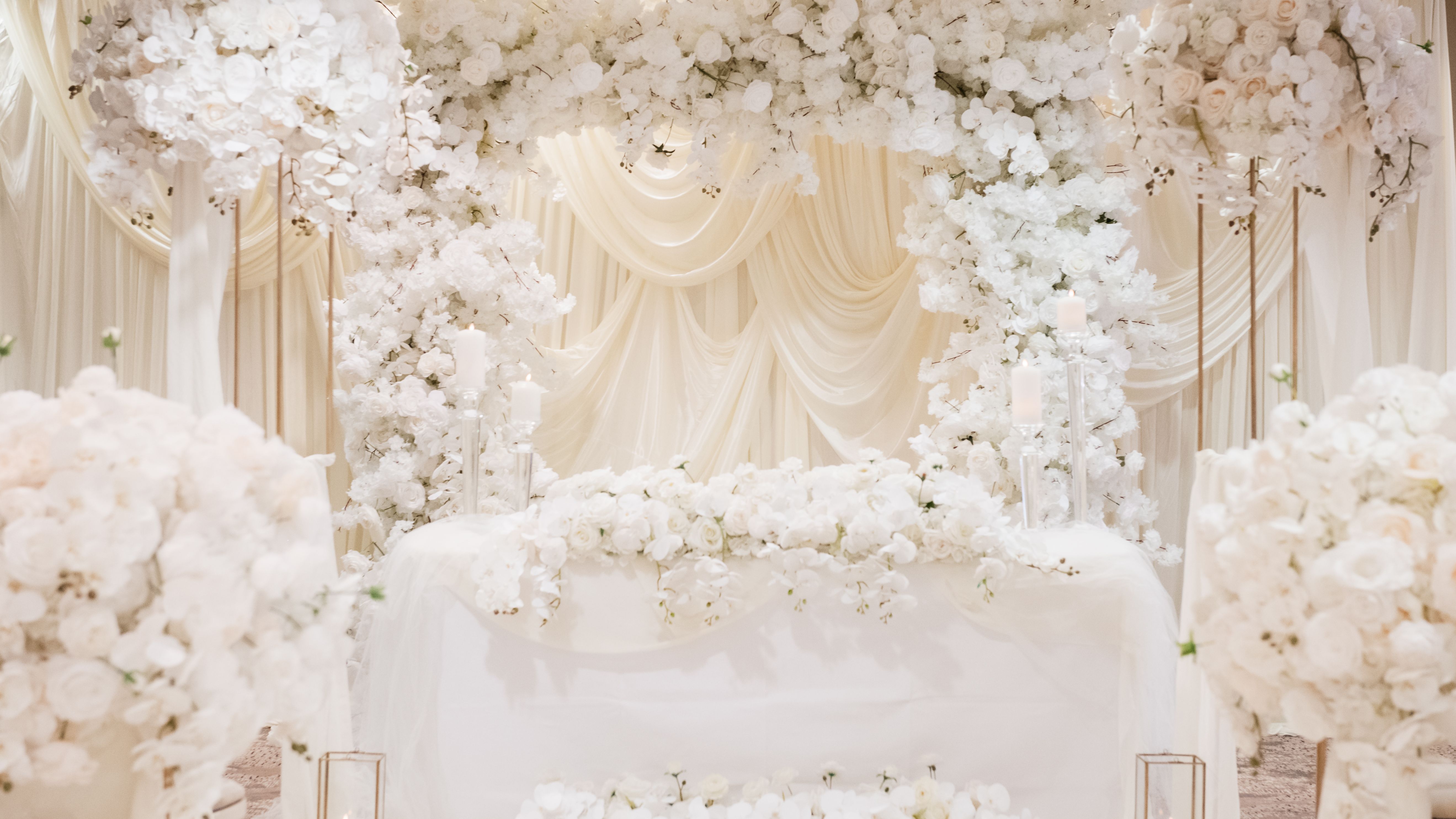 Luxurious wedding altar decorated with white flowers and candles