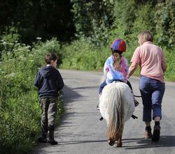 Boscrowan Children on Dotty riding up the road