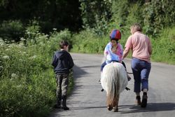 Boscrowan Children on Dotty riding up the road