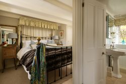 king size bed with soft furnishings around the head board