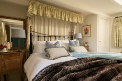 king size bed with soft furnishings around the head board