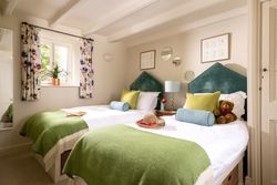 two single beds with beautiful green headboards
