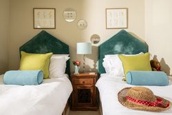 two single beds with beautiful green headboards