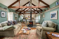 Open plan living area with large lounge and fireplace