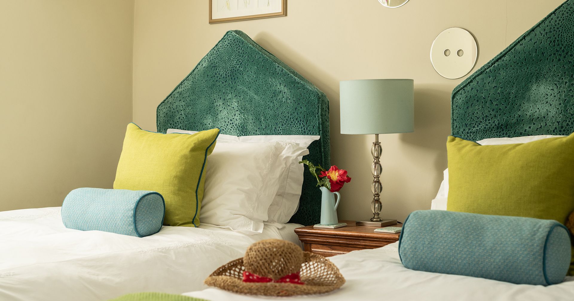 two single beds with beautiful green headboards