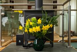 fireplace with flowers in front of it