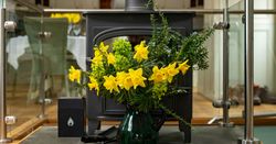 fireplace with flowers in front of it