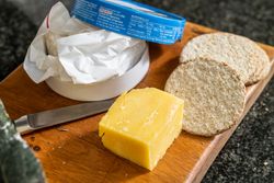 cheese and crackers on a board