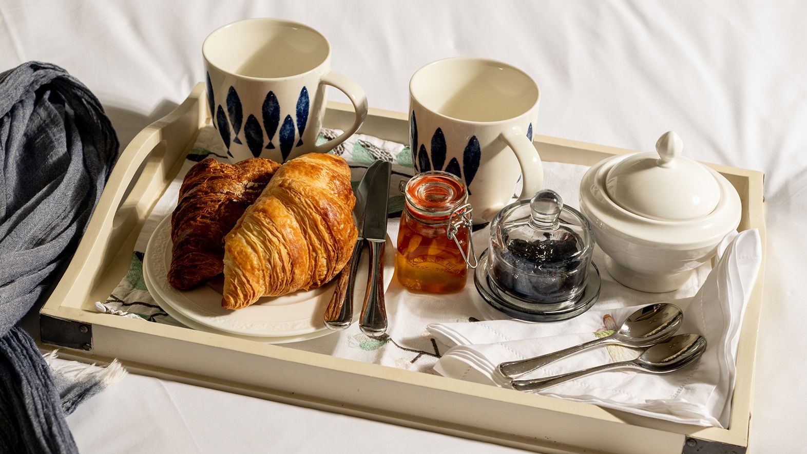 tray of croissants and tea in bed