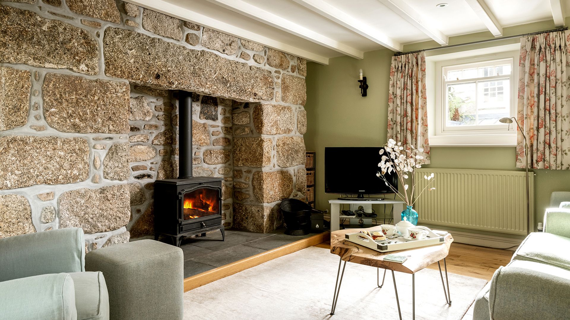 ring and thimble lounge with beams and log burner