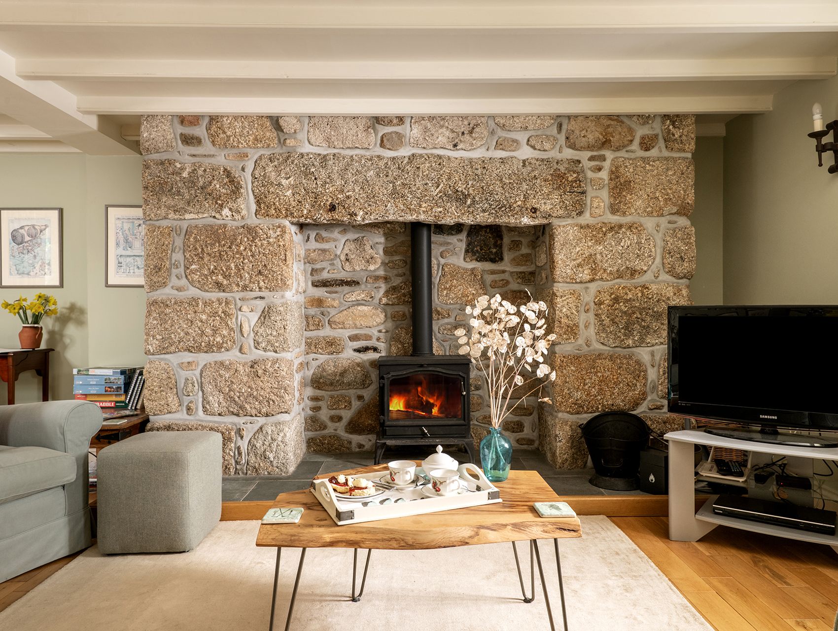 ring and thimble lounge with beams and log burner