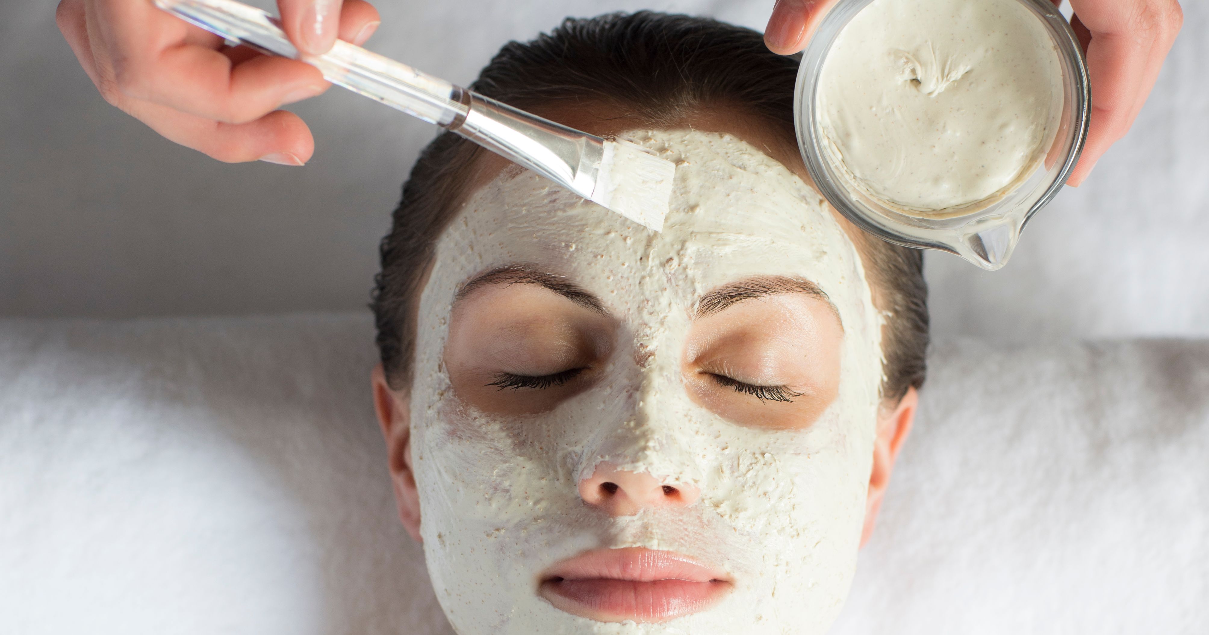 Person receiving a facial mask treatment at a spa