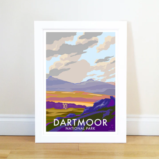 Framed Dartmoor National Park travel poster leaning against a wall on a wooden floor