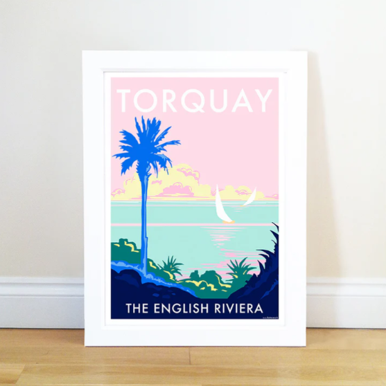 Framed Torquay travel poster with palm tree and pastel seaside scene