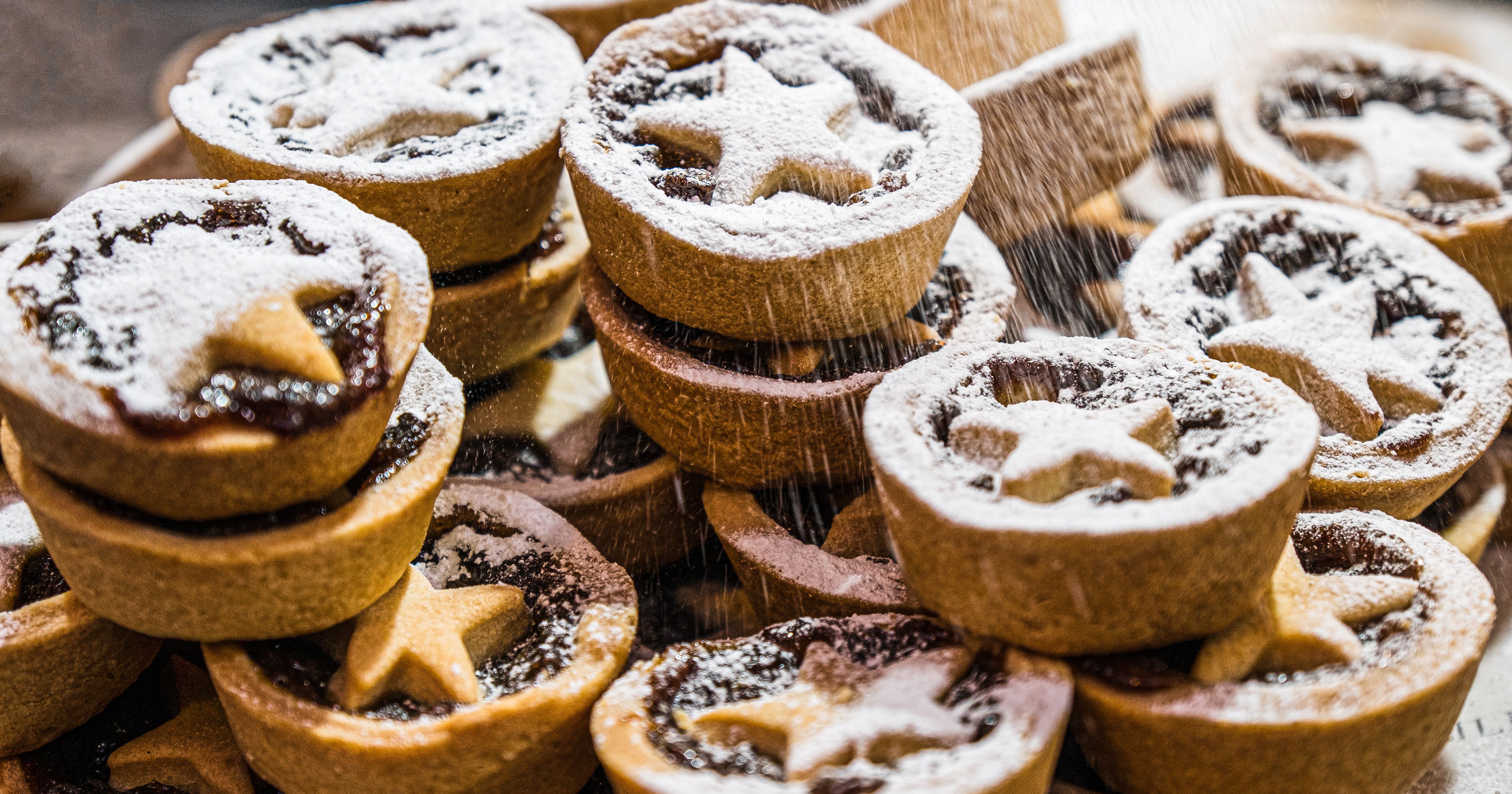Stack of mince pies dusted with icing sugar