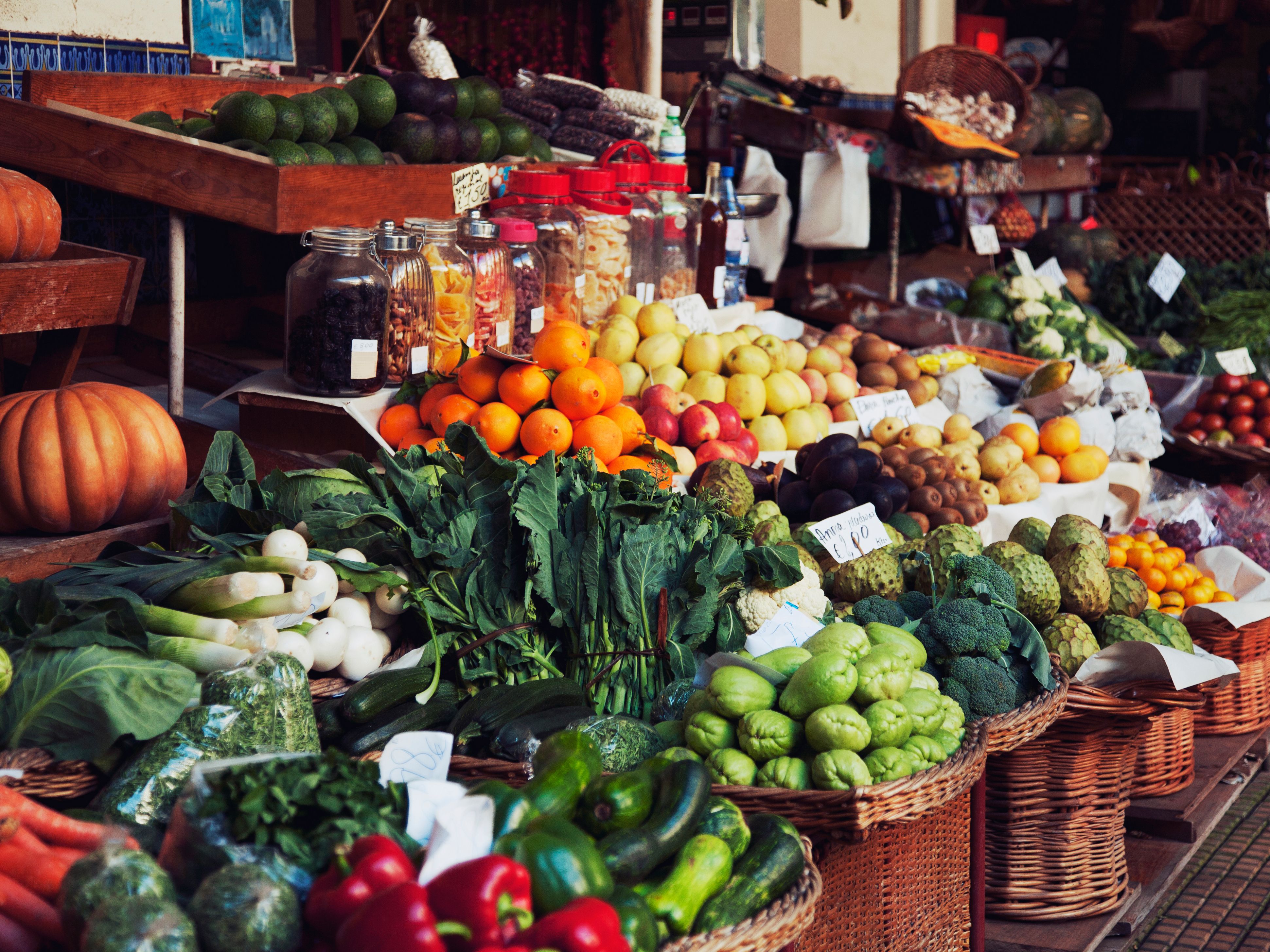 Fresh fruits and vegetables displayed at an outdoor market stand