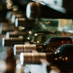 Close-up of wine bottles stored horizontally on a wine rack