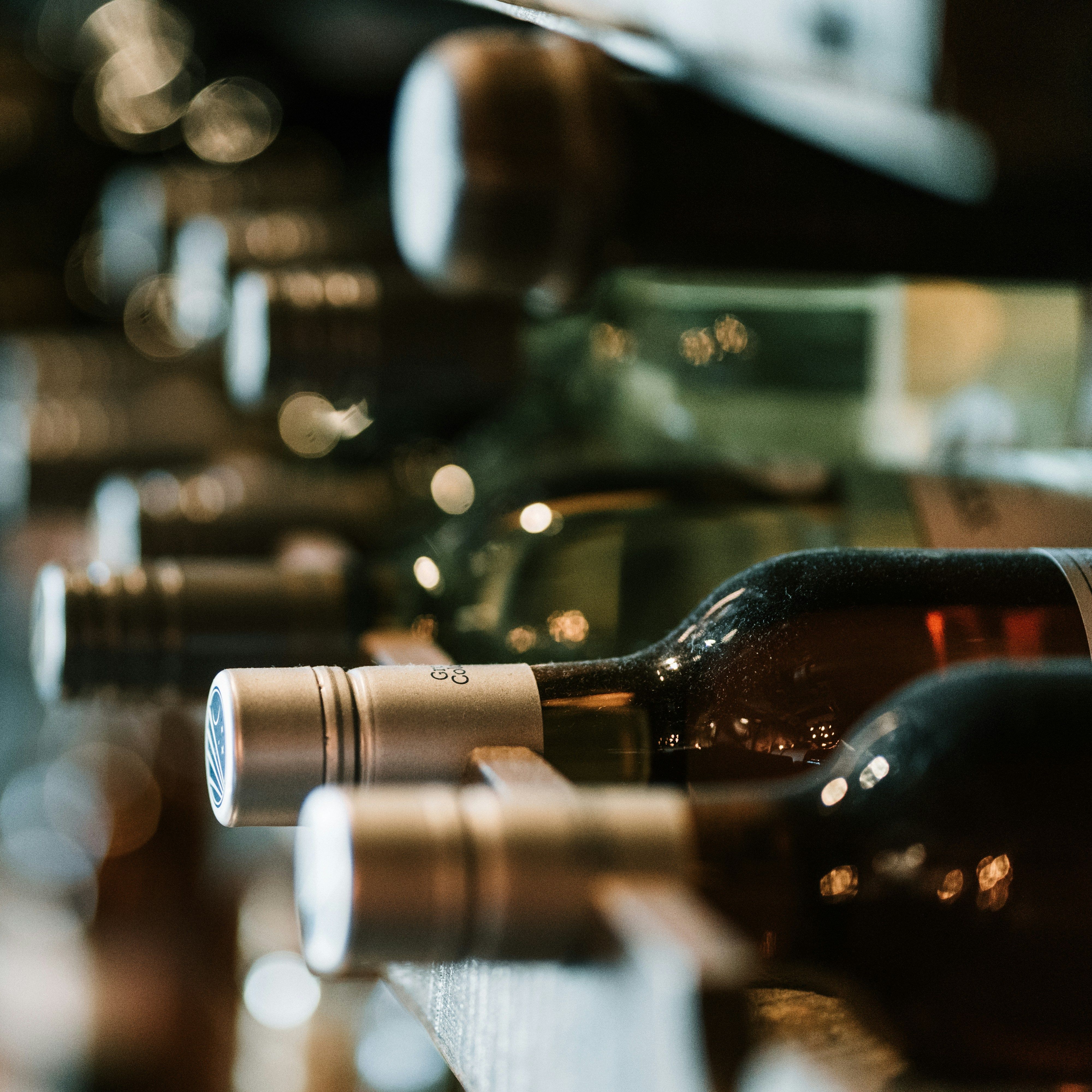 Close-up of wine bottles stored horizontally on a wine rack
